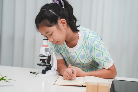 STEM focused student exploring microscope supporting future skills and digital learning growthの写真素材