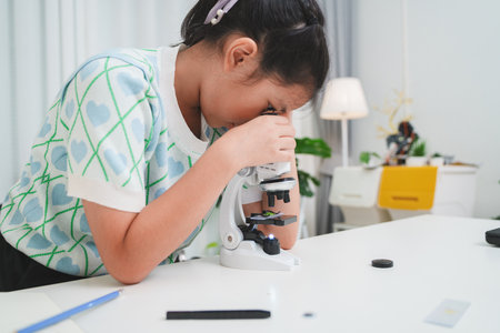 STEM focused student exploring microscope supporting future skills and digital learning growthの写真素材
