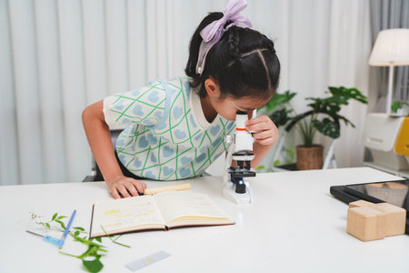 STEM focused student exploring microscope supporting future skills and digital learning growthの写真素材