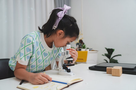 STEM focused student exploring microscope supporting future skills and digital learning growthの写真素材