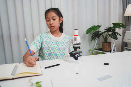Elementary School Girl Taking Notes Science Experiment Microscope STEM Research