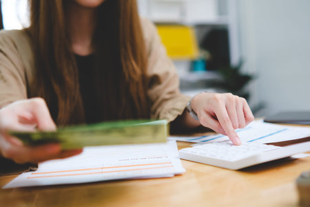 Businesswoman hands or finance with calculator or documents for project budget or expenses in...