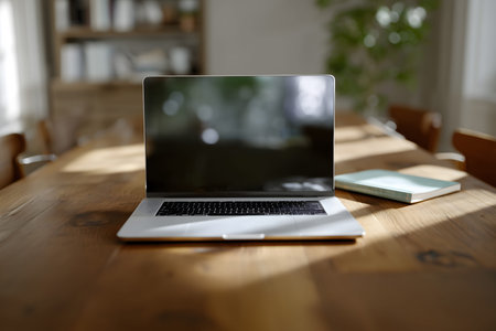Laptop is sitting on a wooden table