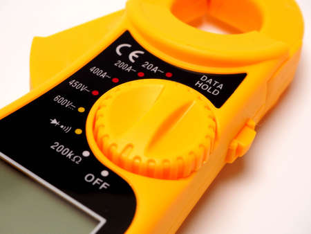 Picture of yellow digital clamp meter that using for measuring electrical current, voltage and resistance. Shoot on white isolated background.の写真素材