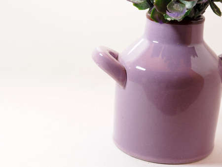 Picture of artificial plastic flower on a ceramic vase. Shoot on white isolated backgroundの写真素材