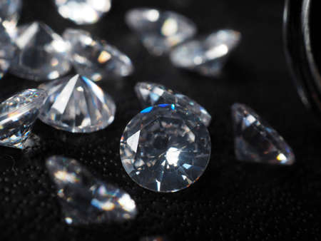 Close up shoot of shiny diamonds. Shoot on a black textured backgroundの写真素材