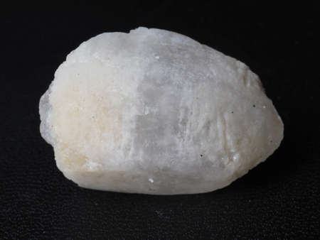 Close up shoot of white gemstone. Shoot on a black textured backgroundの写真素材