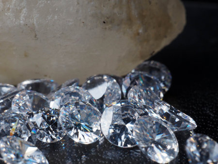 Close up shoot of shiny diamonds. Shoot on a black textured backgroundの写真素材