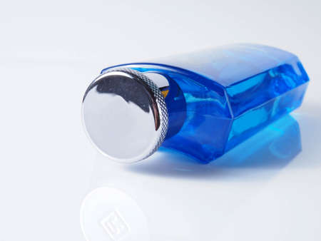 Close up shoot of blue perfume bottle. Shoot on white isolated backgroundの写真素材