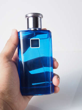 Close up shoot of blue perfume bottle. Shoot on white isolated backgroundの写真素材