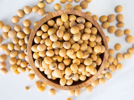 Close up shoot of soybeans on a wooden cup. Shoot on a white isolated backgroundの写真素材