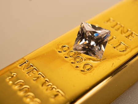 Close up shoot of a briliant diamond on a 999 fine gold bar