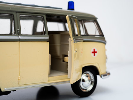 Side view of a classic ambulance miniature toys on a white background