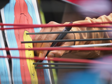 Close up of archer's hand when give marks on the archery target face at a competitionの写真素材