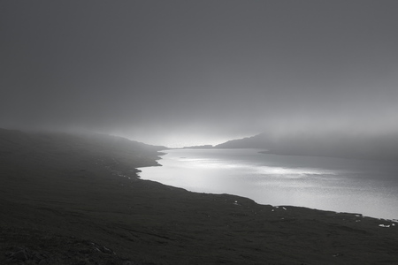 Lake SÃ¸rvÃ¡gsvatn or Leitisvatn lake on Island VÃ¡gar of the Faroe Islands covered by fog and...