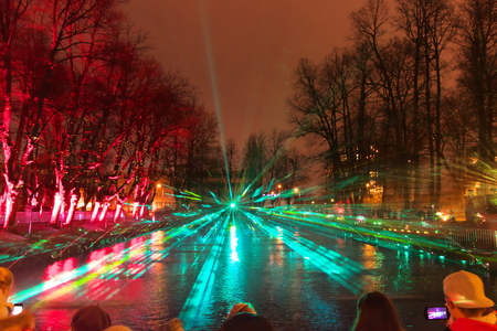 Riga, Latvia - November 17, 2018. Spectators watching spectacular water and multi-colored light and laser show FOREST OF SENSATIONS with fountain elements during Light Festival Staro Riga 2018のeditorial素材