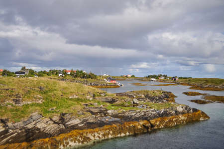 View from ferry to the small fishermen village on island in Helgeland archipelago in the Norwegian...