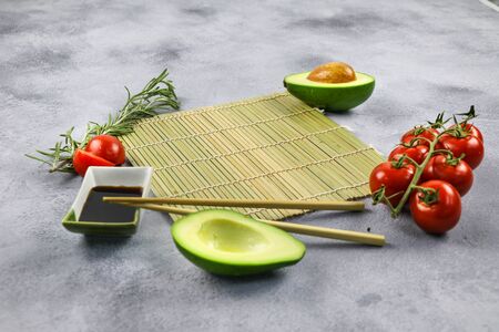 Mockup for food. Avocado, cherry, soy sauce, bamboo board.の写真素材