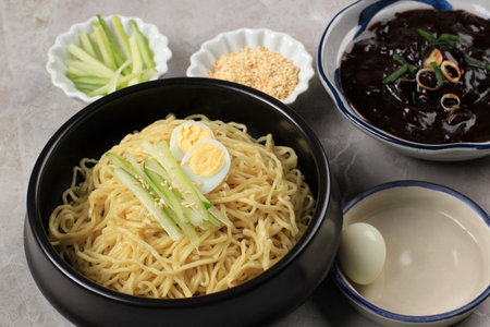 Jajangmyeon or JJajangmyeon Korean Noddle with Black Bean Sauce, Served with Cucumber and Sesame Seedの写真素材
