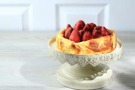 Basque Burnt Cheese Cake on Black Background, Viral Cheese Cake with Strawberry on Top. Copy Space...