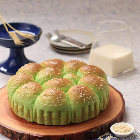 Roti Sobek Pandan or Pandan Pull Out Bread on Rustic Wooden Log Board. Isolated, Copy Space for Text