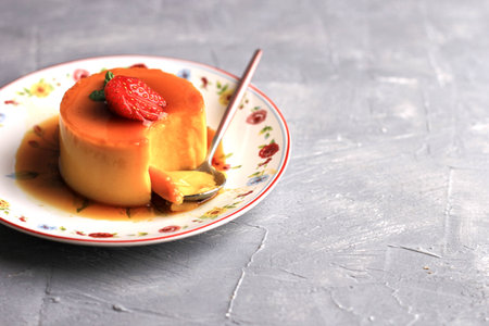 Homemade Dessert Caramel Pudding with Strawberry Topping. Copy Space for Textの写真素材