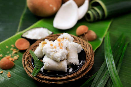 Kue Putu, Indonesian Traditional Cake Made from RIce Flour, Palm SUgar, Pandan Leaf, and Shredded Coconut. Come with Cylinder Shape with Bamboo Pipeの写真素材