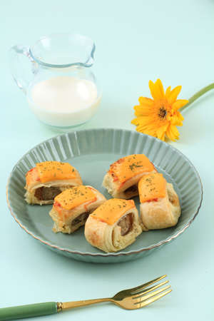 Puff Pastry Roll with Sausage and Cheese on Top, Served with Milkの写真素材