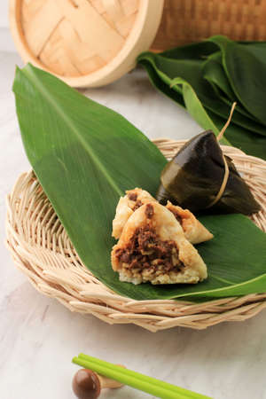 Zongzi or Bakcang. Chinese Savoury Sticky Rice Dumplings Wrapped with Bamboo Leavesの写真素材