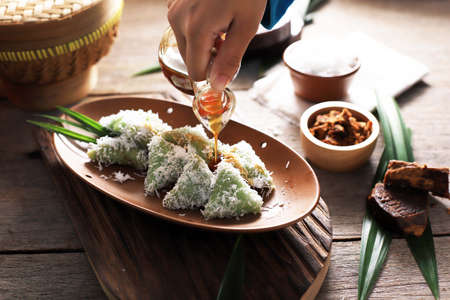 Pour Palm Sugar on Lupis, Indonesian Traditional Snack Made From Sticky Rice, Wrapped with Banana...