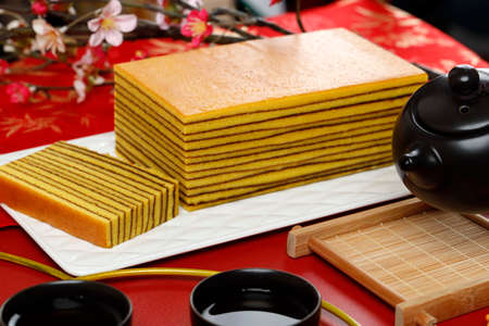 Close up view of Lapis Legit or Thousand Layers Cake on White Plate. Chinese new year Red Conceptの写真素材
