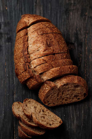 Sliced Sourdough Bread on Wooden Rustic Table, Close Up Artisan Texture