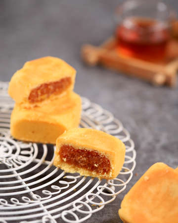 Pineapple Cake is a Sweet Traditional Taiwanese Pastry Containing Butter, Flour, Egg, Sugar, and Pineapple Jam. Served with Tea. Selected Focusの写真素材