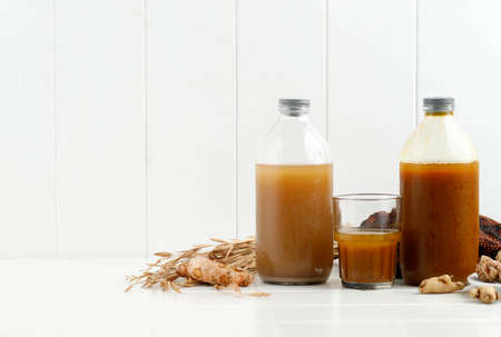 Jamu Indonesian, Traditional herba Drink Called Beras kencur and Kunyit Asem, White Concept Celan Modern Healthy Drink, Copy Spaceの写真素材