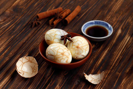 Chinese Tea Herbal Eggs, Cha Ye Dan, Black Tea Boiled Eggs in Spices Star Anise and Cinnamon Stickの写真素材