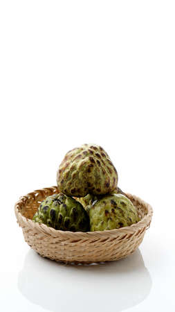 Fresh Sugar Apple fruit or Custard Apple or annona cherimoya ,sweetsop in basket with white background isolatedの写真素材