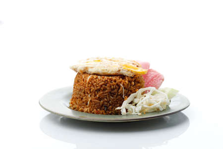 Nasi Goreng Rendang. Indonesian fried rice with Beef Rendang and Sunny Side Egg, Isolated on Whiteの写真素材