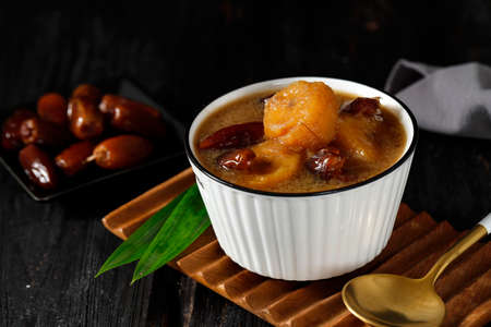 Kolak Pisang Kurma or Banana Dates Fruit Compote Made from Sliced Banana and Dates Fruit Stew in Coconut Milk and Brown Sugar. Popular during Ramadan as a Iftar Menu.の写真素材