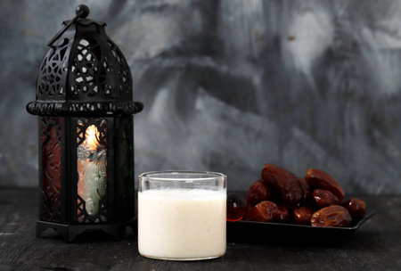 Susu Kurma or Dates Fruit Smoothie Made from Milk and Dates Palm Fruits, on Wooden Background with Ramadan Concept Lanternの写真素材