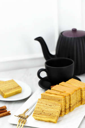 Lapis Legit or Thousand Layers Cake on White Plate. Chinese new year Red Concept, Selected Focusの写真素材