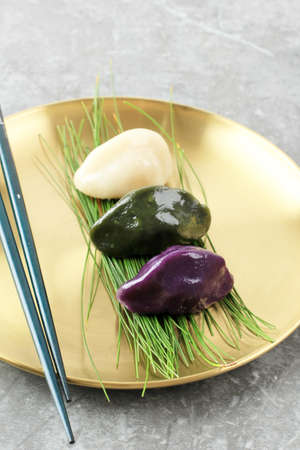 Traditional Chuseok Day Food, Korean Half Moon Shaped Rice Cake or Songpyeon. Made from Korean Rice Flour with Sesame Seed or Chopped Nuts, Honey, or Red Bean Pasteの写真素材