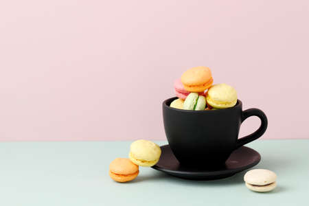 Mini Macaroon on Black Cup, Copy Space on Pastel Backgroundの写真素材