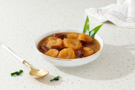 Kolak Pisang Kurma, Banana Compote with Dates Fruit, Popular Food Beverages for Iftar in Indonesia. Kolak Made from Coconut Milk and Palm Sugar with Various Ingredientの写真素材