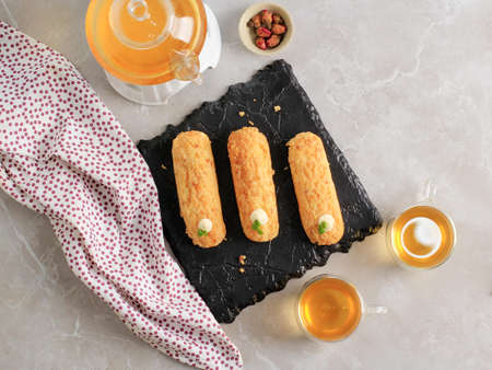 Home made cake eclairs. Traditional eclairs, profitroles classic, eclairs french. Served with Tea