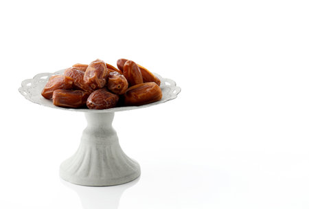 Fresh dates on white plate isolated on white background. Copy Spaceの写真素材