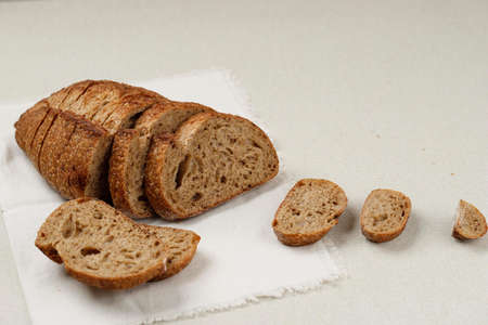 Bread, Traditional Sourdough Bread Cut into Slices on a cCeam Background. Concept of Traditional...