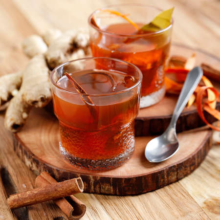 Wedang Uwuh, Traditional Warm Herb Drink with Various Spice from Jogjakarta, Indonesia. Served on a Glass with Rock Sugar. Contains a Cinnamon, Nutmeg, Wood from Secang Tree, and Cloves Leaves.の写真素材