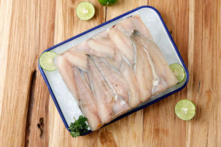 Top View Frozen Catfish Fillet on Wooden Table