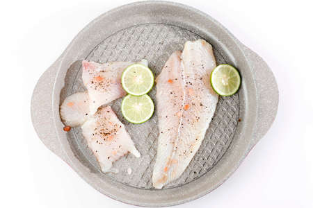 John Dory Fillet, Saint Peter Fillet with LIme, Salt, Blackpepper. Top View on White Tableの写真素材