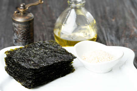 Crispy Salted Nori Laver Sheet on White Plate, Popular in Japan and Korea for Sushi and Kimbapの写真素材